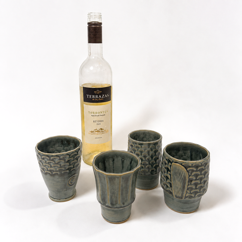 Four ceramic cups stacked to form a koi fish