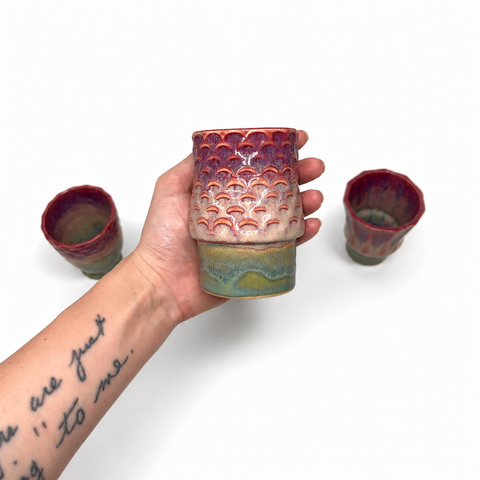 Four ceramic cups stacked to form a koi fish