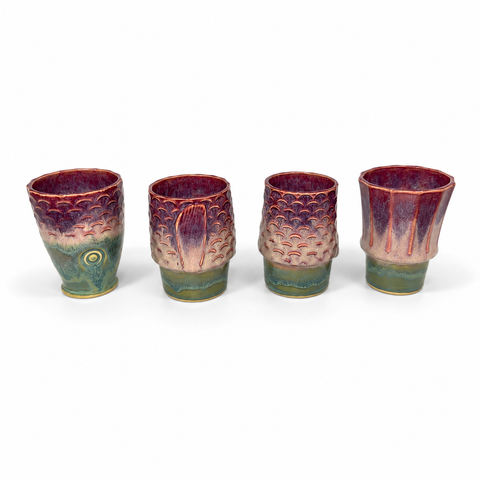 Four ceramic cups stacked to form a koi fish