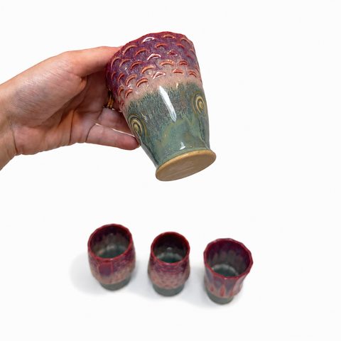 Four ceramic cups stacked to form a koi fish