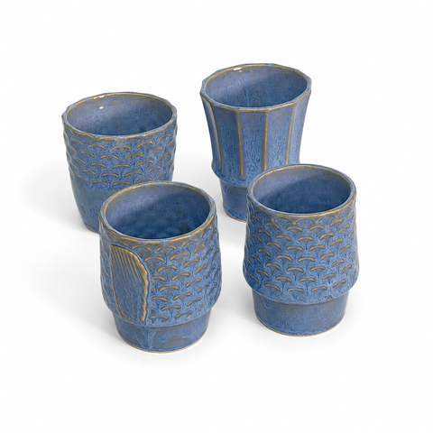 Four ceramic cups stacked to form a koi fish