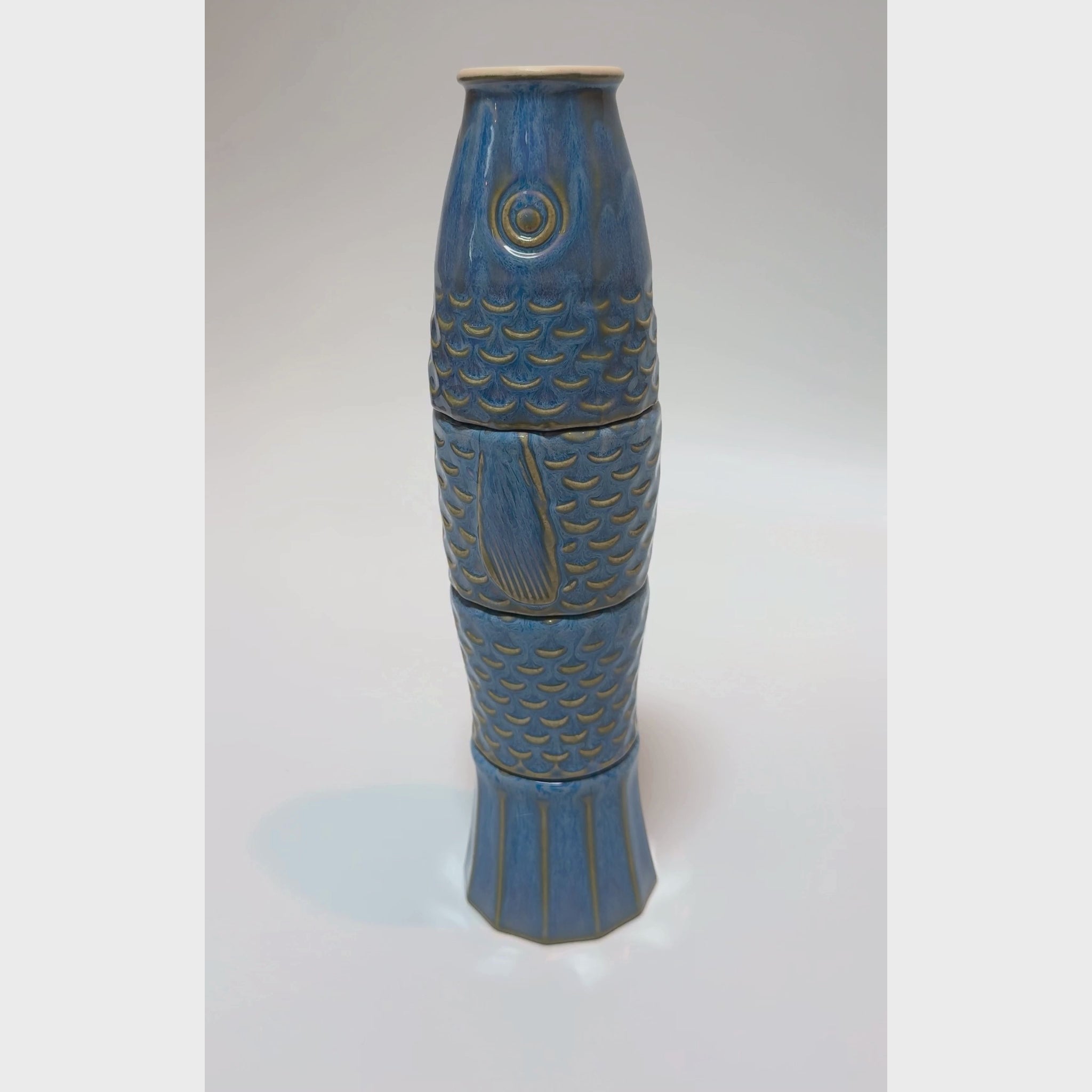 Four ceramic cups stacked to form a koi fish