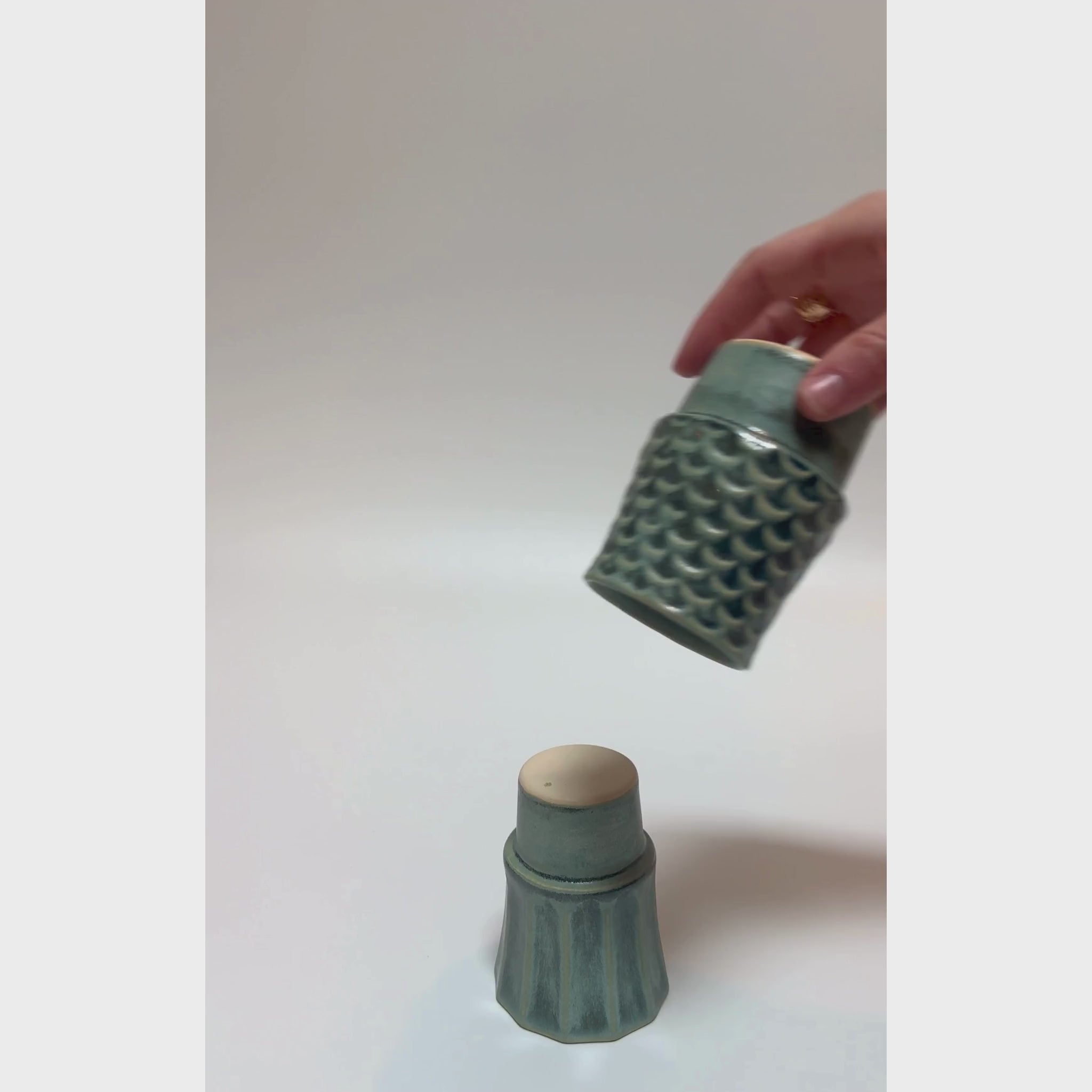 Four ceramic cups stacked to form a koi fish